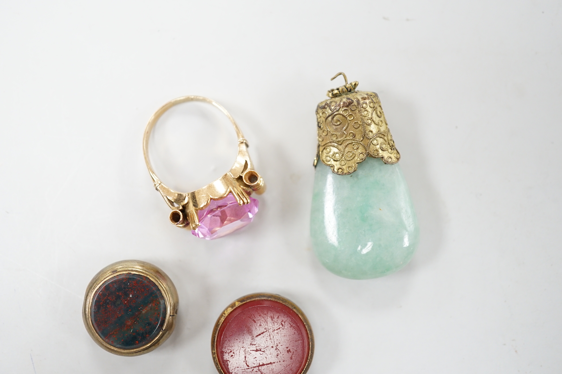 Two damaged carnelian set fobs and two other items including a yellow metal and pink stone ring.